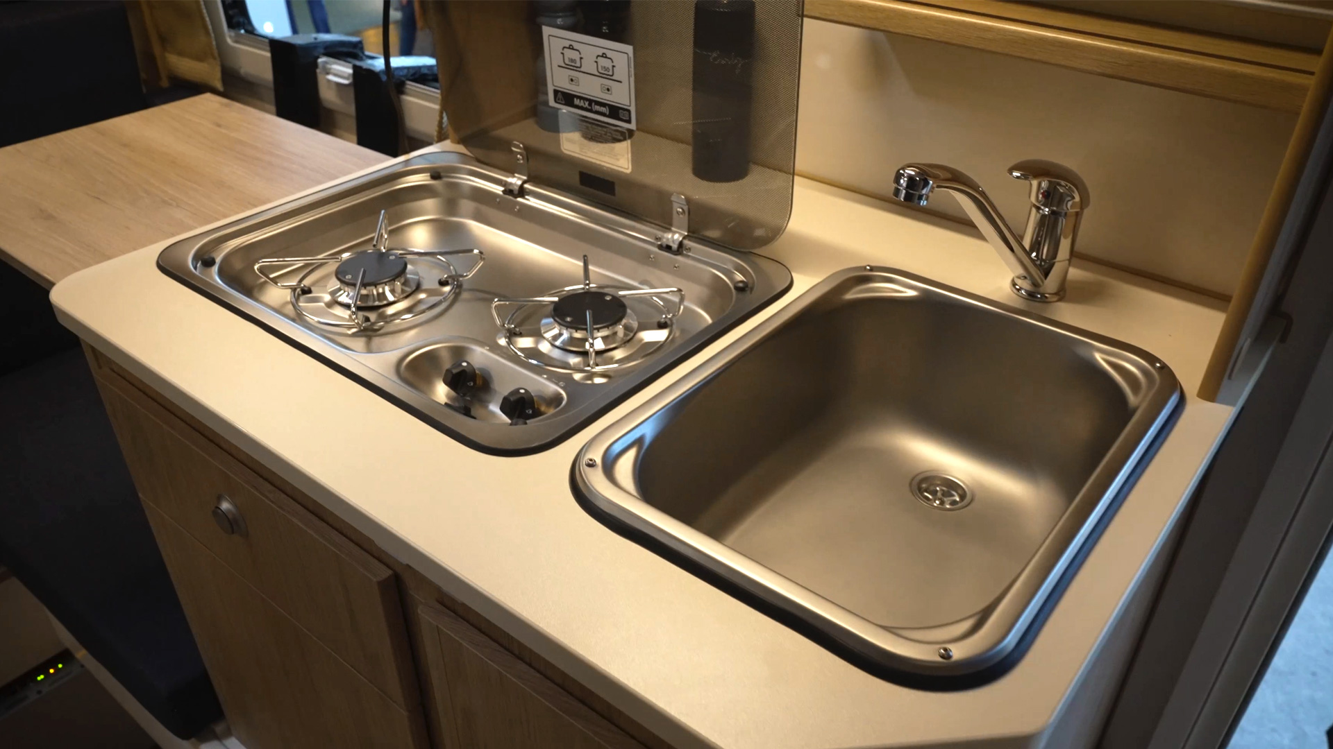 camper kitchen with stove sink and fridge