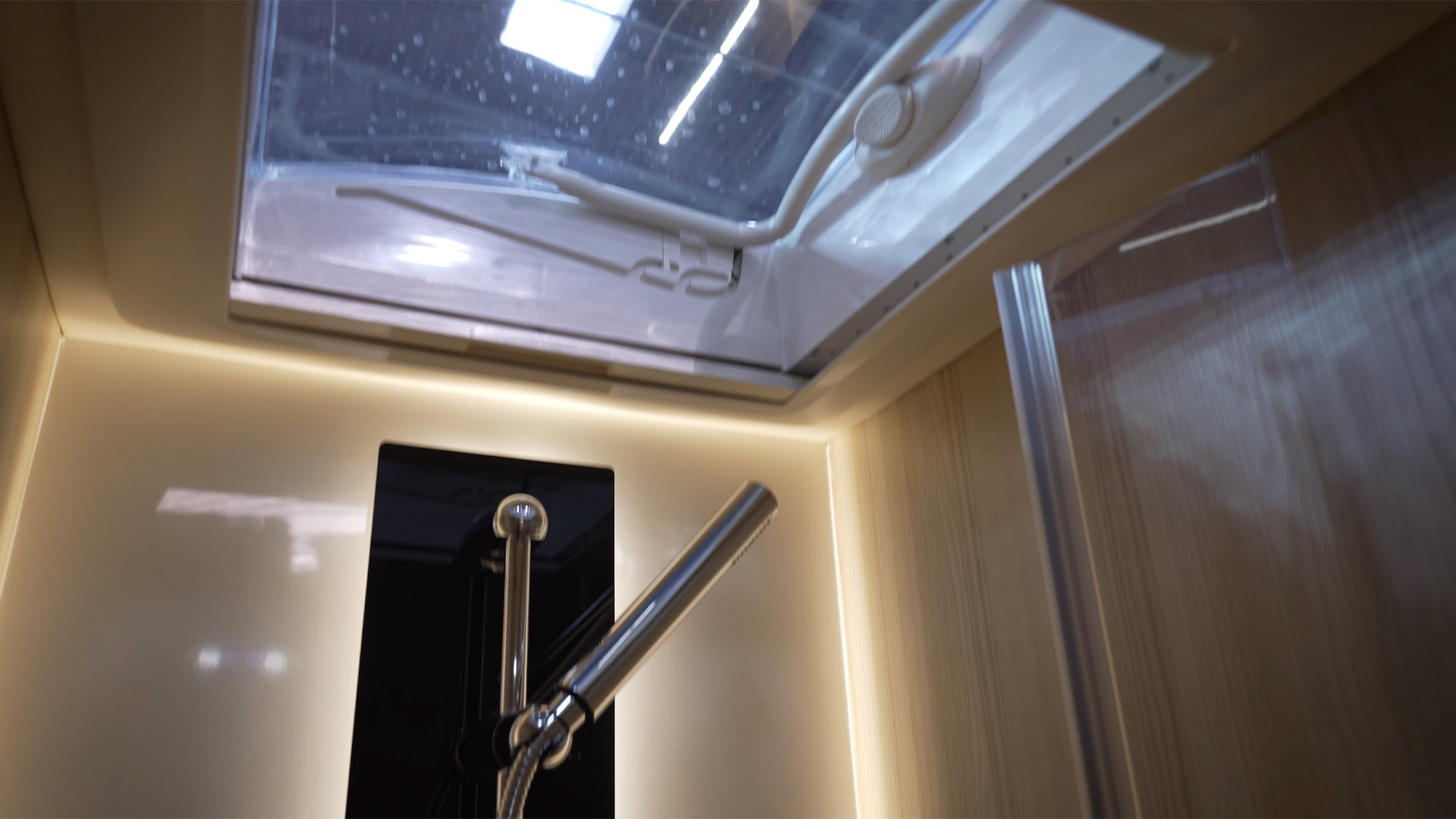 camper shower with roof hatch for daylight and ventilation